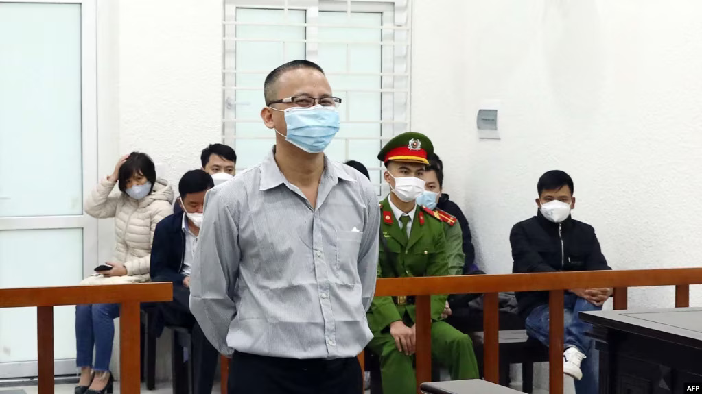 This picture taken and released by the Vietnam News Agency shows Vietnamese activist Le Van Dung in a courtroom during his trial in Hanoi, March 23, 2022, as he was sentenced to 5 year in jail.