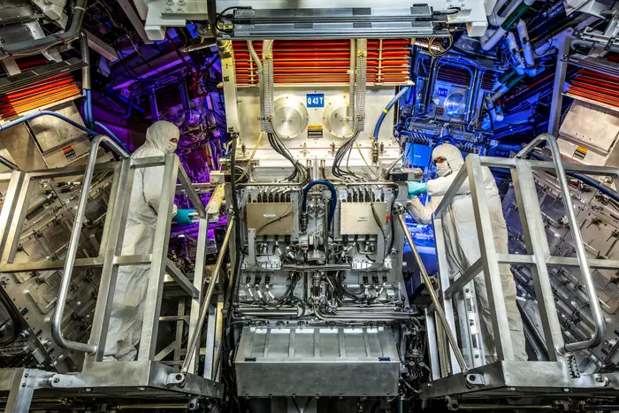 Operators inspect the National Ignition Facility target chamber where the fusion ignition experiments take place. (Image from Insider)