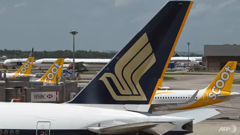 A Singapore Airlines plane is parked beside Scoot aircraft on the tarmac at Singapore's Changi Airport on Mar 15, 2021. (File photo: AFP/Roslan Rahman / channelnewsasia.com)
