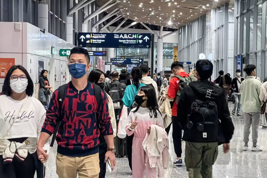 Travelers walk through the Kuala Lumpur International Airport on Dec. 20. As the number of tourists surges across Southeast Asia, so too are COVID cases. (Photo by Norman Goh / asia.nikkei.com)